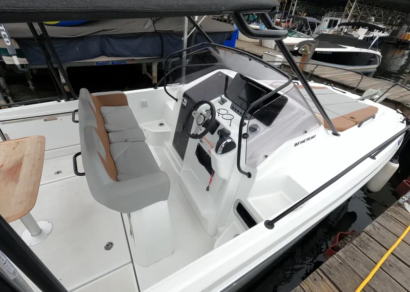 Slide: The Image of 2022 Beneteau Flyer 8 SUNdeck boat interior with helm, seating, and docked at marina. - 17