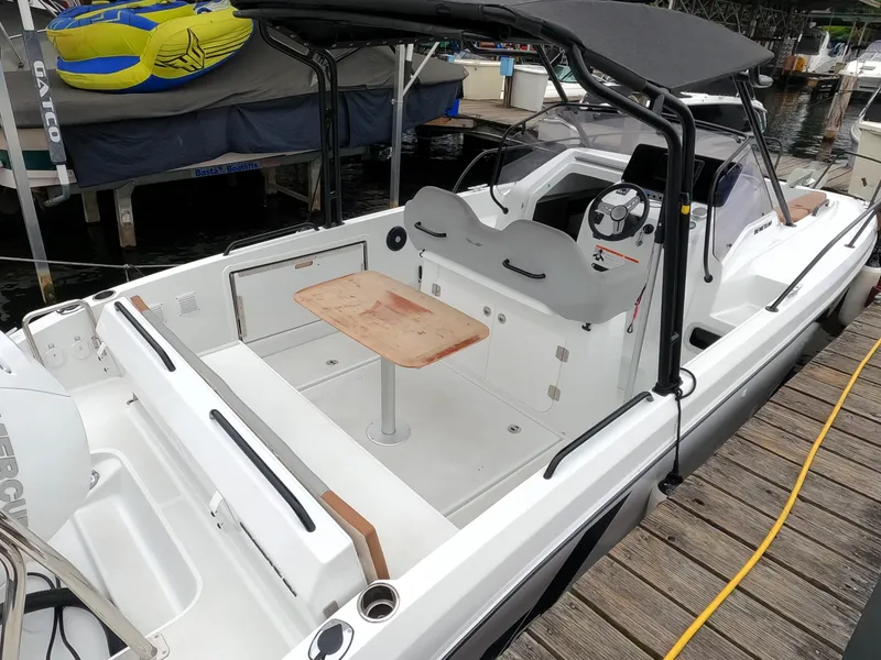 Slide: The Image of 2022 Beneteau Flyer 8 SUNdeck boat docked, featuring spacious seating and a central table. - 30