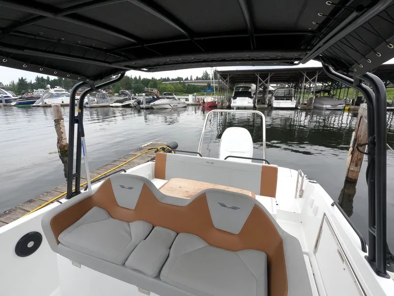 Slide: The Image of 2022 Beneteau Flyer 8 SUNdeck at a marina, featuring comfortable seating and a spacious deck. - 34