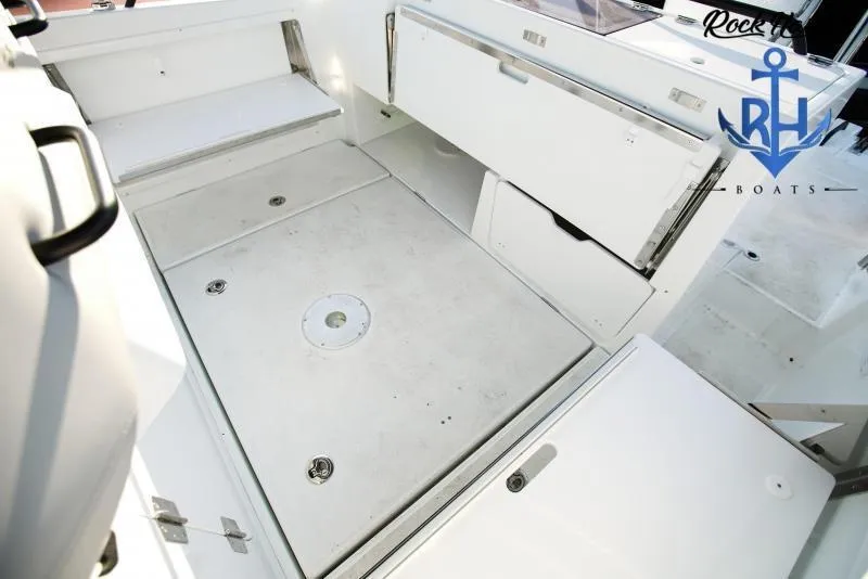 Slide: The Image of 2022 Beneteau Flyer 8 SUNdeck boat interior with storage compartments and seating. - 9