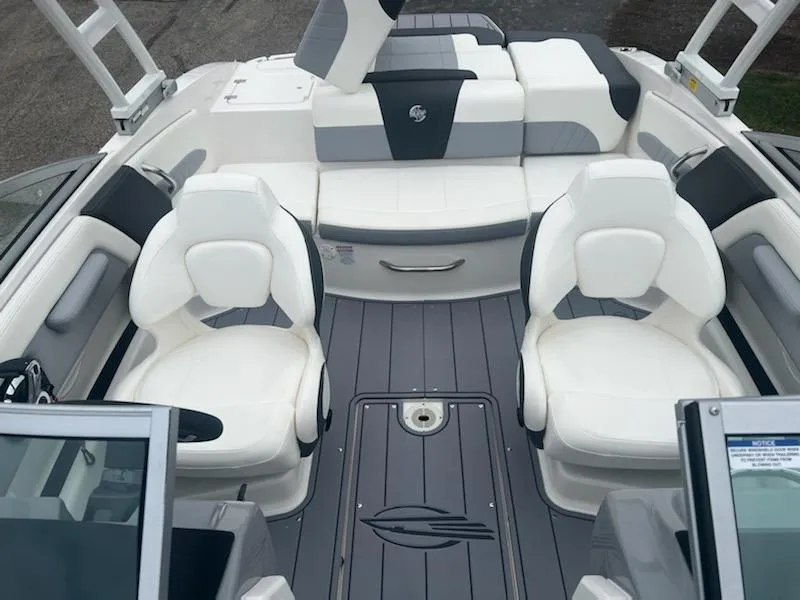 Slide: The Image of 2023 Chaparral 21 Surf boat interior with white and gray seating. - 3