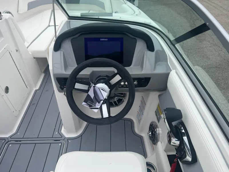 Slide: The Image of 2023 Chaparral 21 Surf boat dashboard with steering wheel and control panel. - 4