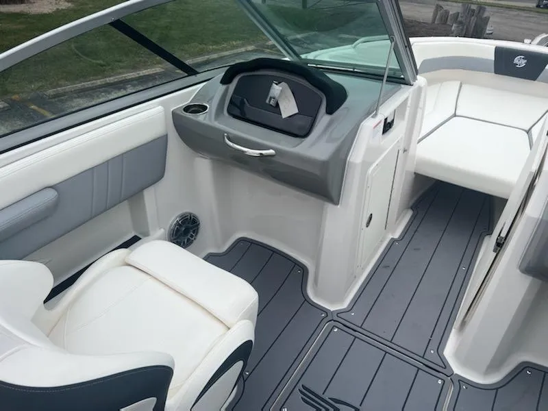 Slide: The Image of 2023 Chaparral 21 Surf boat interior with white and gray seating. - 5