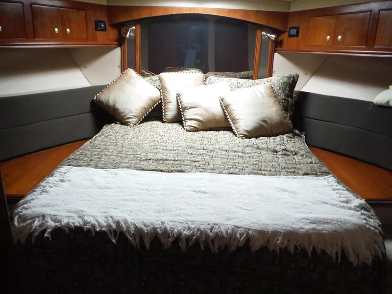 Slide: The Image of Luxurious bedroom in 2005 Cruisers Yachts 455 Express Motoryacht with plush bedding and pillows. - 24