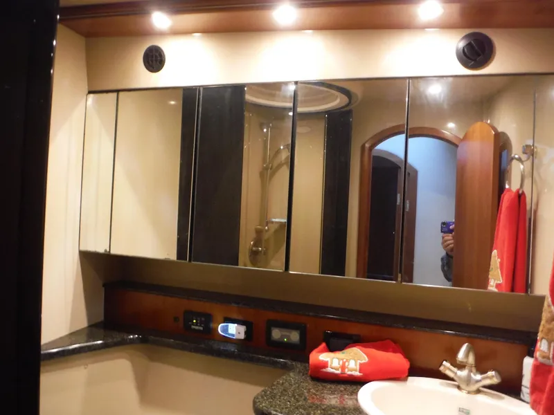 Slide: The Image of 2005 Cruisers Yachts 455 Express Motoryacht bathroom with mirrored cabinets and granite countertop. - 29