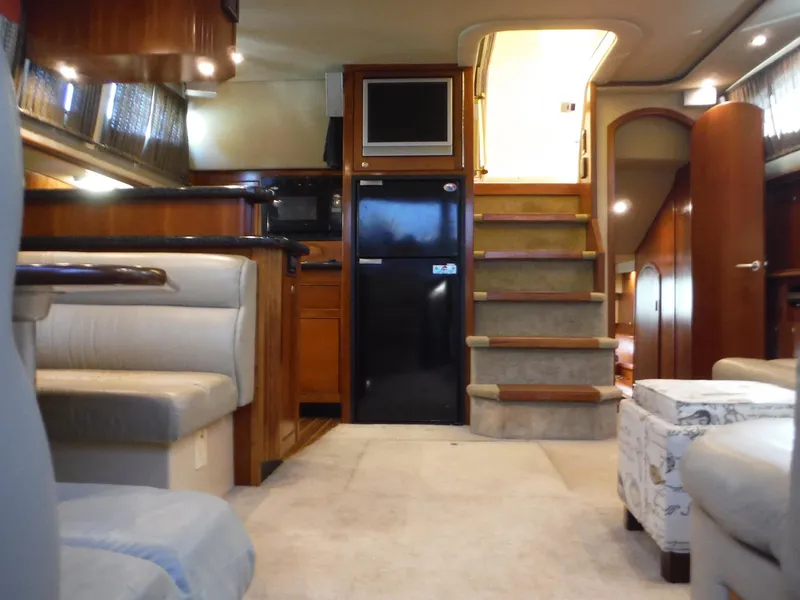 Slide: The Image of Interior of 2005 Cruisers Yachts 455 Express Motoryacht with stairs, seating, and kitchen area. - 31