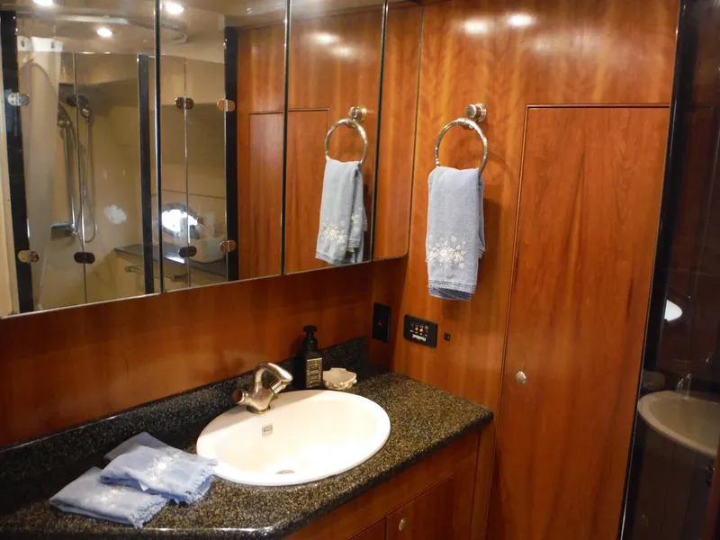 Slide: The Image of Luxurious bathroom in 2005 Cruisers Yachts 455 Express Motoryacht with wood cabinetry and granite countertop. - 36