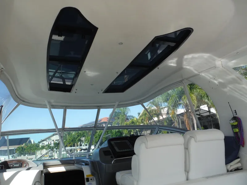 Slide: The Image of Interior of 2005 Cruisers Yachts 455 Express Motoryacht with panoramic windows and white seating. - 4