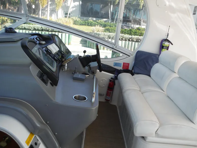 Slide: The Image of 2005 Cruisers Yachts 455 Express Motoryacht helm station with white leather seating. - 10