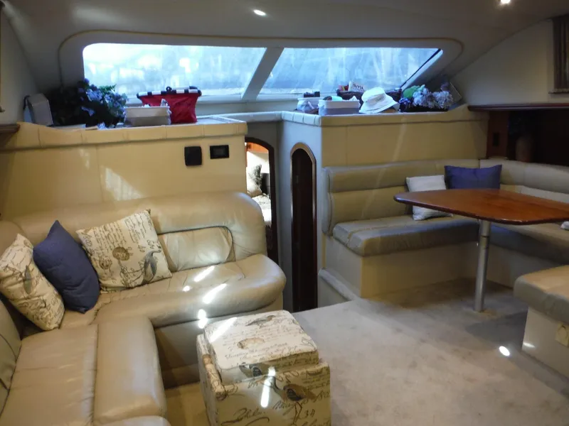 Slide: The Image of Interior of 2005 Cruisers Yachts 455 Express Motoryacht with beige leather seating and dining area. - 22