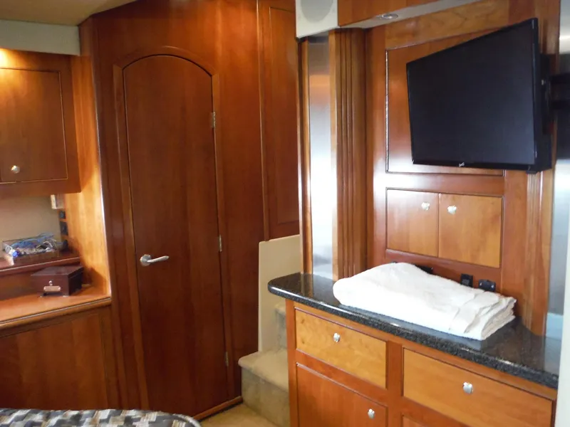Slide: The Image of Interior of 2005 Cruisers Yachts 455 Express Motoryacht with wooden cabinetry and mounted TV. - 41