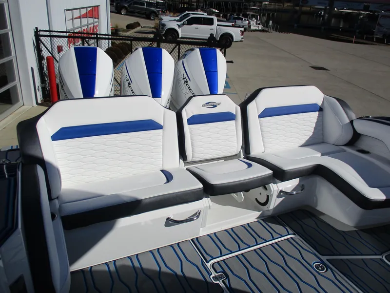 Slide: The Image of 2021 Sunsation 40CCX boat with white and blue seating and triple outboard engines. - 14