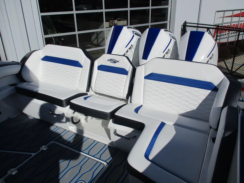 Slide: The Image of 2021 Sunsation 40CCX boat with white and blue seating and triple outboard engines. - 15