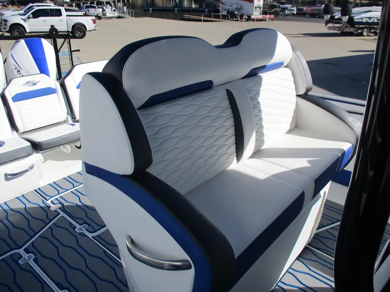 Slide: The Image of 2021 Sunsation 40CCX boat with white and blue cushioned seating. - 17