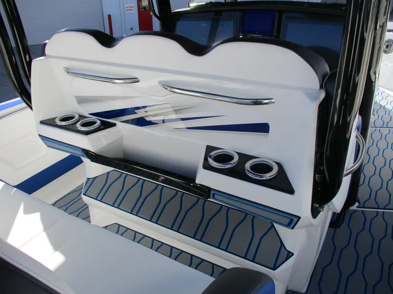 Slide: The Image of 2021 Sunsation 40CCX boat interior with cup holders and blue accents. - 18