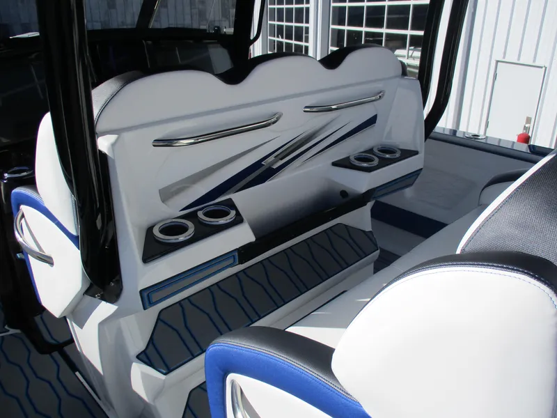 Slide: The Image of 2021 Sunsation 40CCX boat interior with white and blue seating and cup holders. - 19
