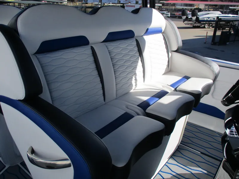 Slide: The Image of 2021 Sunsation 40CCX boat interior seating with blue and white upholstery. - 21