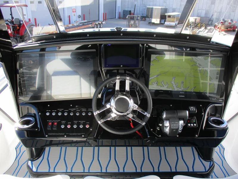 Slide: The Image of 2021 Sunsation 40CCX boat dashboard with navigation screens and control panel. - 23