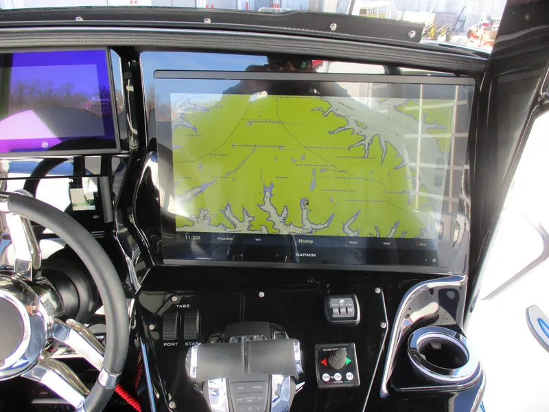 Slide: The Image of Dashboard of 2021 Sunsation 40CCX boat with navigation screen and controls. - 24