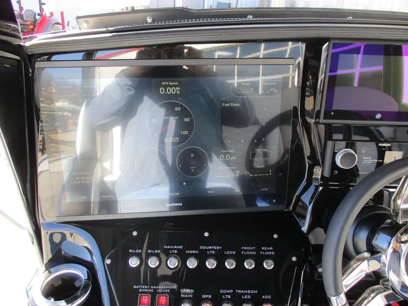 Slide: The Image of Dashboard of a 2021 Sunsation 40CCX boat with Garmin display and control switches. - 25