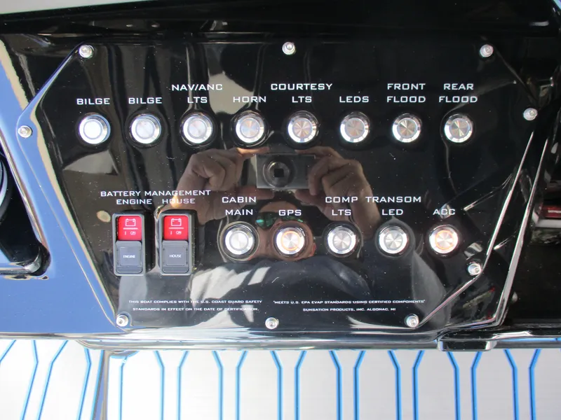 Slide: The Image of Control panel of a 2021 Sunsation 40CCX boat with various switches and buttons. - 27