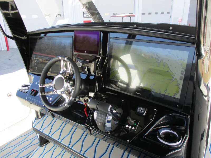 Slide: The Image of 2021 Sunsation 40CCX boat dashboard with advanced navigation and control systems. - 28