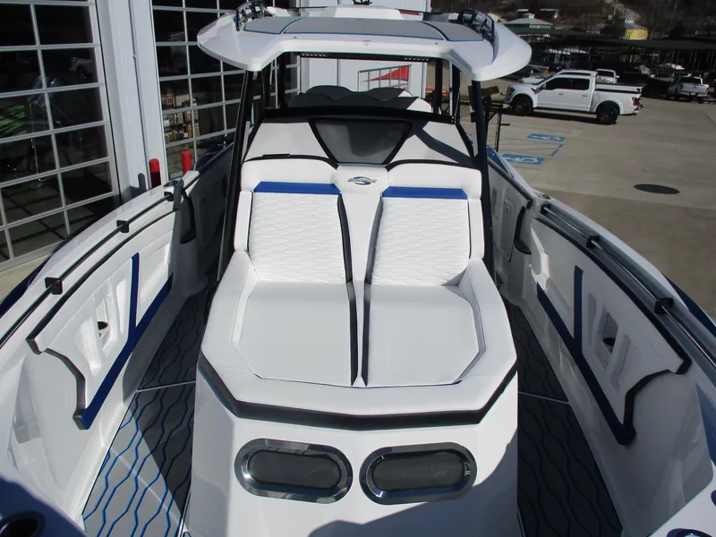Slide: The Image of 2021 Sunsation 40CCX boat with white and blue seating in a marina. - 38