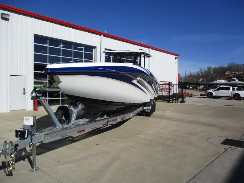 Slide: The Image of 2021 Sunsation 40CCX boat on a trailer outside a white and red building. - 4