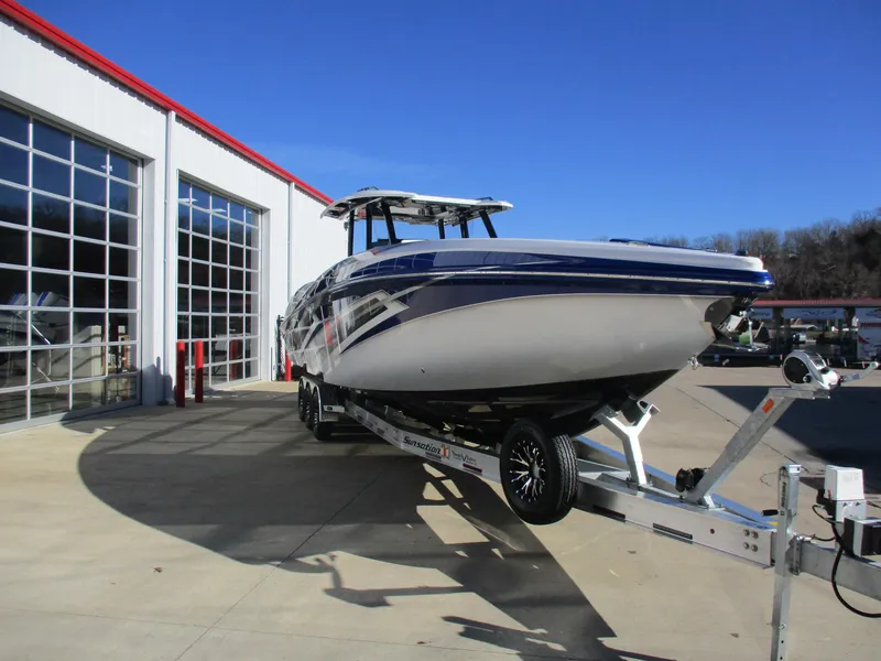 Slide: The Image of 2021 Sunsation 40CCX boat on a trailer outside a garage with glass doors. - 6