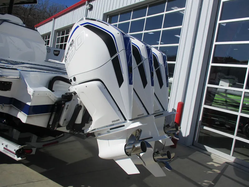 Slide: The Image of 2021 Sunsation 40CCX boat with triple outboard engines in a marina. - 9