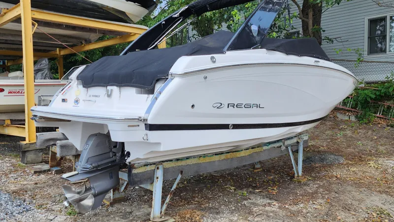 The Image of 2017 Regal 22 FasDeck boat on a stand, covered and stored outdoors. - 0