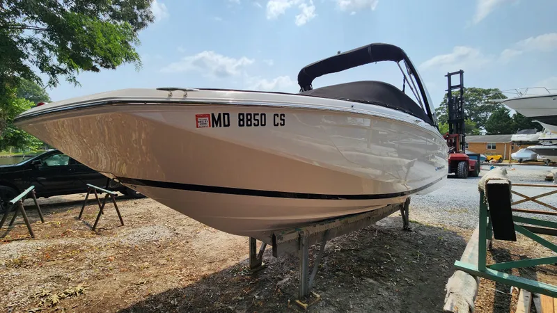 Slide: The Image of 2017 Regal 22 FasDeck boat on trailer, sunny day, registration number visible. - 2