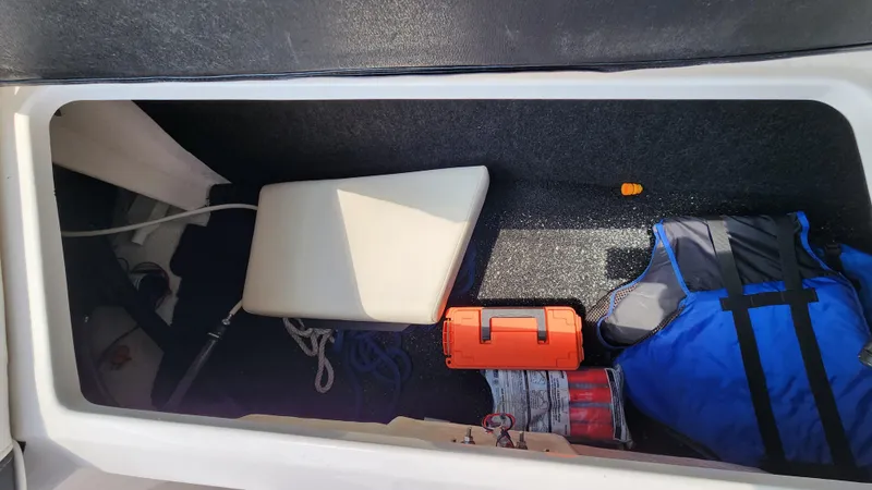 Slide: The Image of Storage compartment of 2017 Regal 22 FasDeck with life jacket and gear. - 22