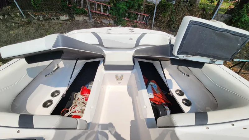 Slide: The Image of 2017 Regal 22 FasDeck boat interior with open storage compartments and seating. - 23