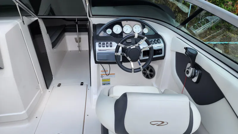 Slide: The Image of 2017 Regal 22 FasDeck boat interior with steering wheel and dashboard controls. - 24