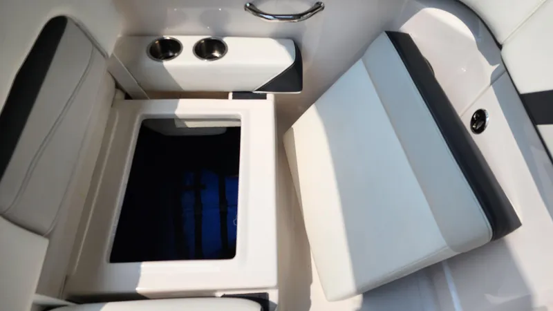 Slide: The Image of 2017 Regal 22 FasDeck boat interior with open storage compartment and cup holders. - 26