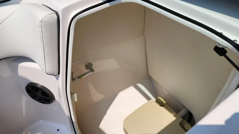 Slide: The Image of 2017 Regal 22 FasDeck boat interior storage compartment with beige seating. - 28
