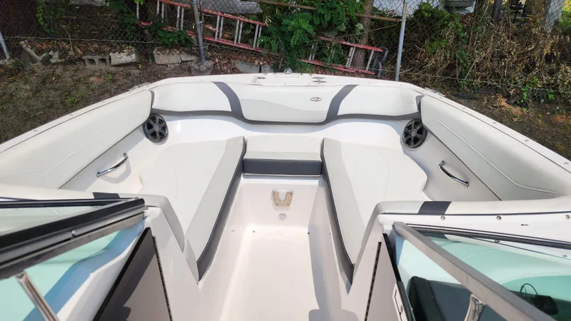 Slide: The Image of 2017 Regal 22 FasDeck boat interior with white seating and speakers. - 31
