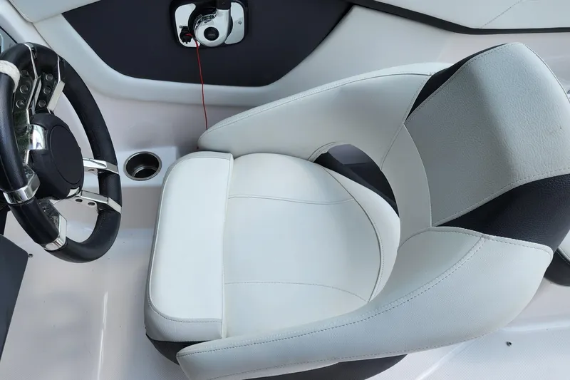 Slide: The Image of 2017 Regal 22 FasDeck boat interior with sleek steering wheel and comfortable seating. - 32