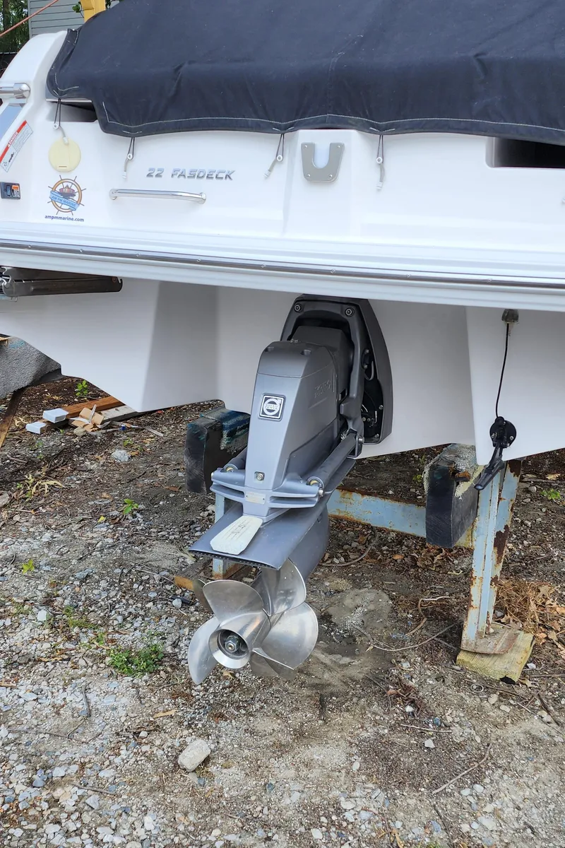 Slide: The Image of 2017 Regal 22 FasDeck boat with covered stern and visible outboard motor. - 33