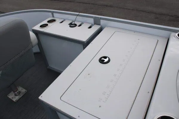 Slide: The Image of 2023 Lowe SF212 boat interior with storage compartments and cup holders. - 6