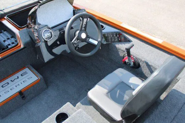 Slide: The Image of 2023 Lowe Stinger 178 boat interior with steering wheel and control panel. - 7