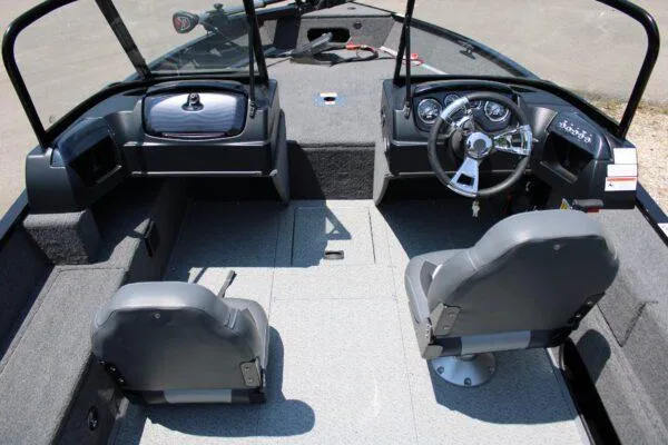 Slide: The Image of 2023 Lowe FM1675 boat interior with dual seats and steering console. - 10