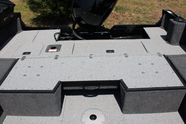 Slide: The Image of 2023 Lowe FM1800 boat deck with storage compartments and motor. - 10