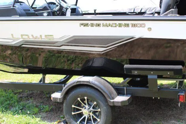 Slide: The Image of 2023 Lowe FM1800 Fishing Machine boat on trailer, side view. - 2