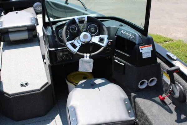 Slide: The Image of 2023 Lowe FM1800 boat cockpit with steering wheel and control panel. - 7