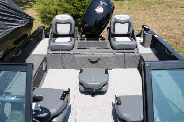 Slide: The Image of 2023 Lowe FM1800 boat interior with seating and outboard motor. - 9