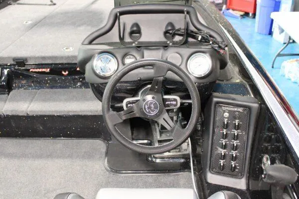 Slide: The Image of 2023 Phoenix 921 ELITE boat dashboard with steering wheel and control panel. - 10