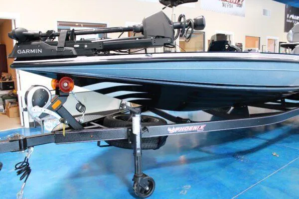 Slide: The Image of 2023 Phoenix 921 ELITE boat on trailer in showroom. - 13
