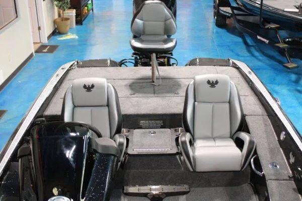 Slide: The Image of 2023 Phoenix 921 ELITE boat interior with three gray seats and blue flooring. - 8
